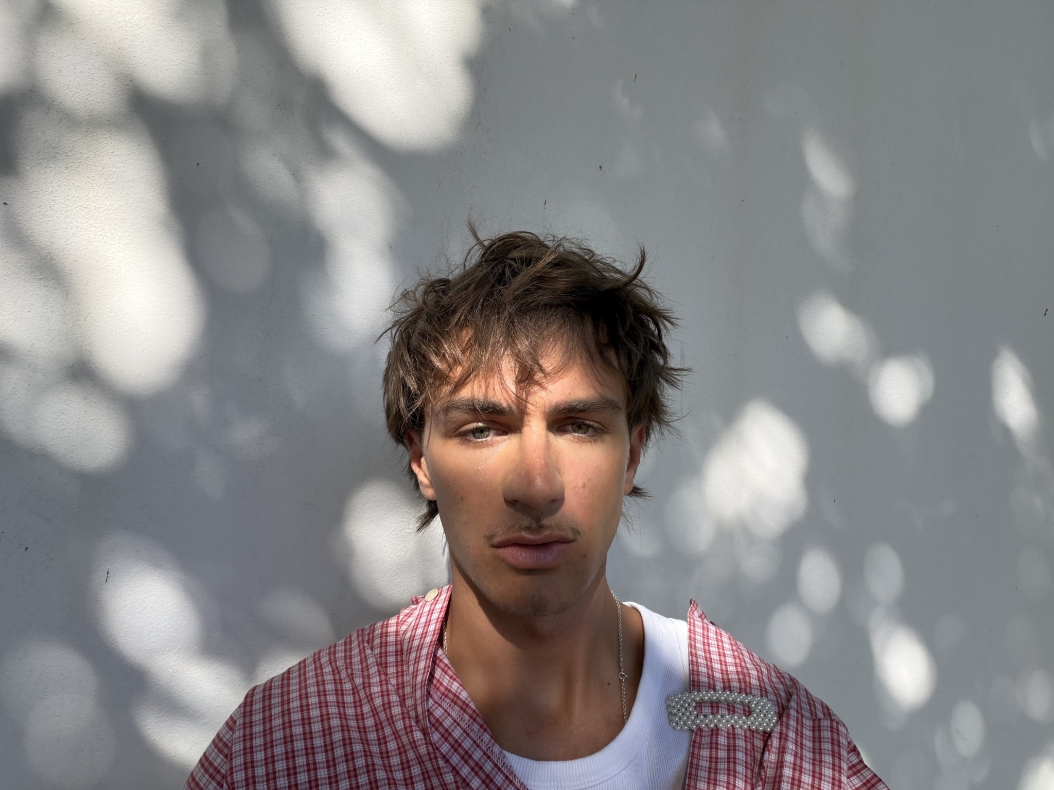 Jupp Simon in a red checked shirt photographed in natural light